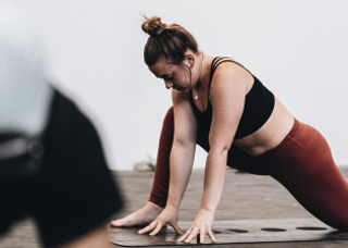 Woman performing yoga pose in class