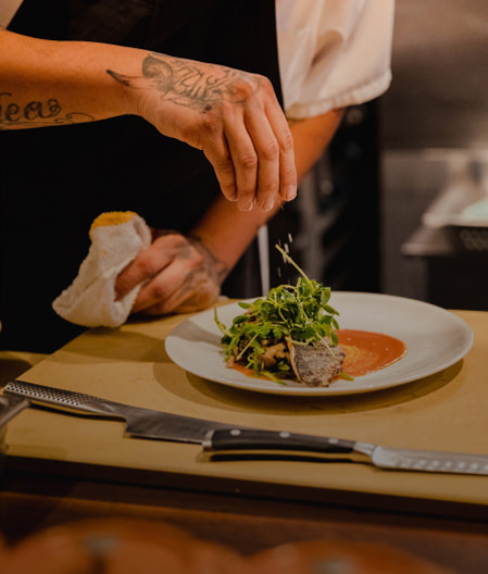 Chef putting finishings on prepared meal