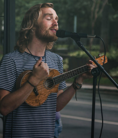 Musician playing guitar outside